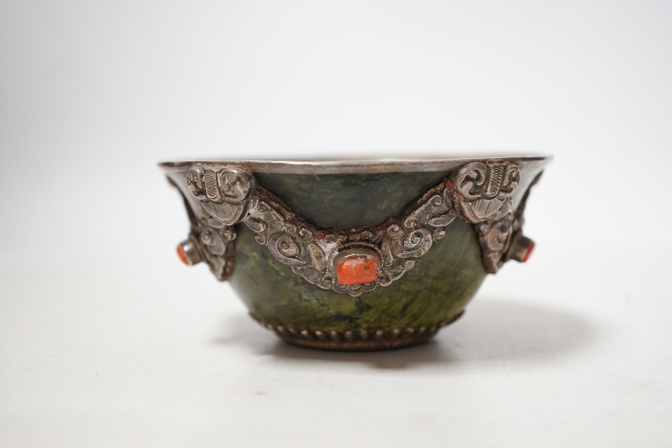 A Tibetan silver cup and a silver mounted hard stone bowl